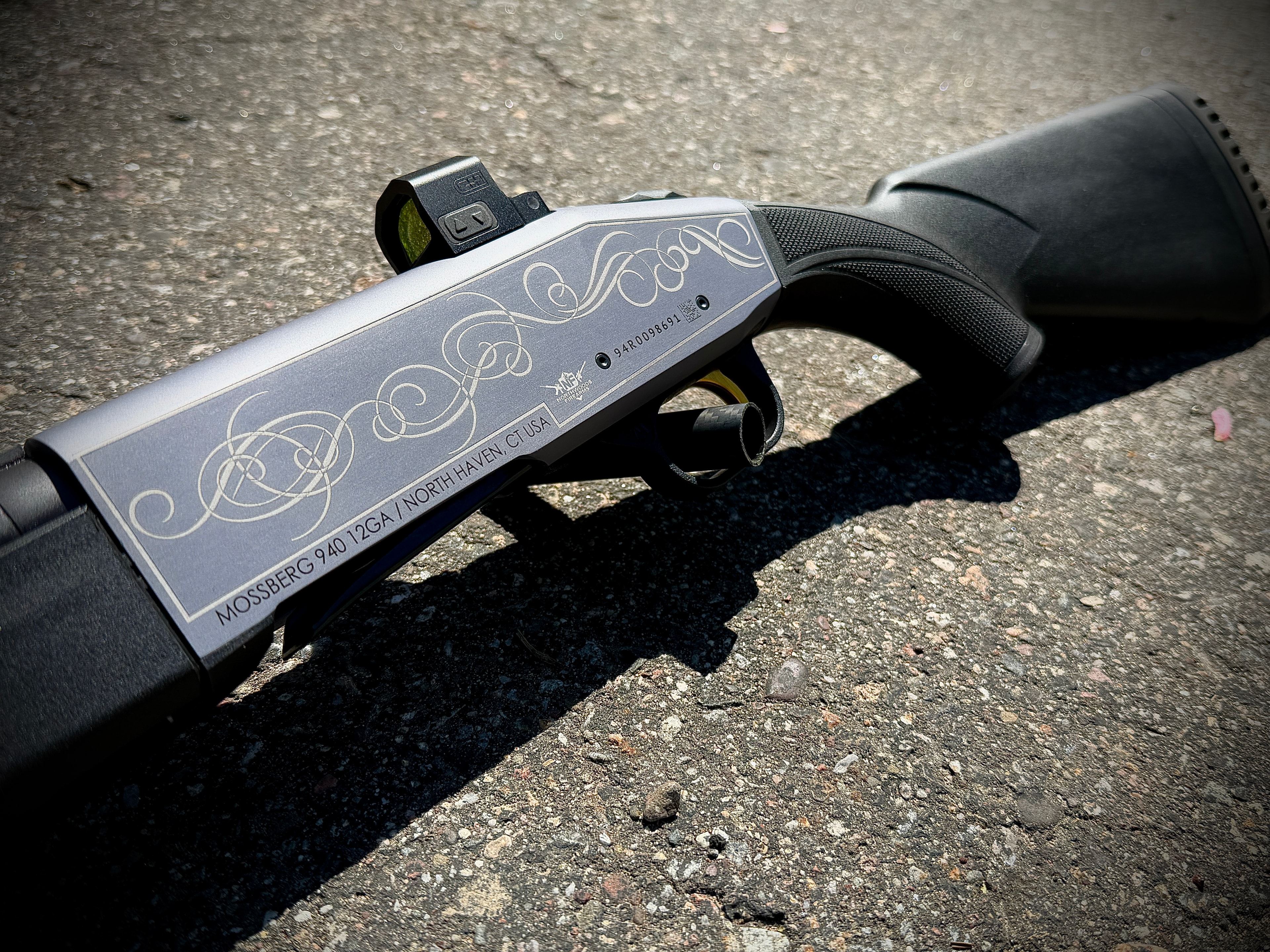 Laser-engraved Celtic scrollwork and knotwork design on Mossberg 940 12GA receiver with red dot optic by Northwoods Firearms