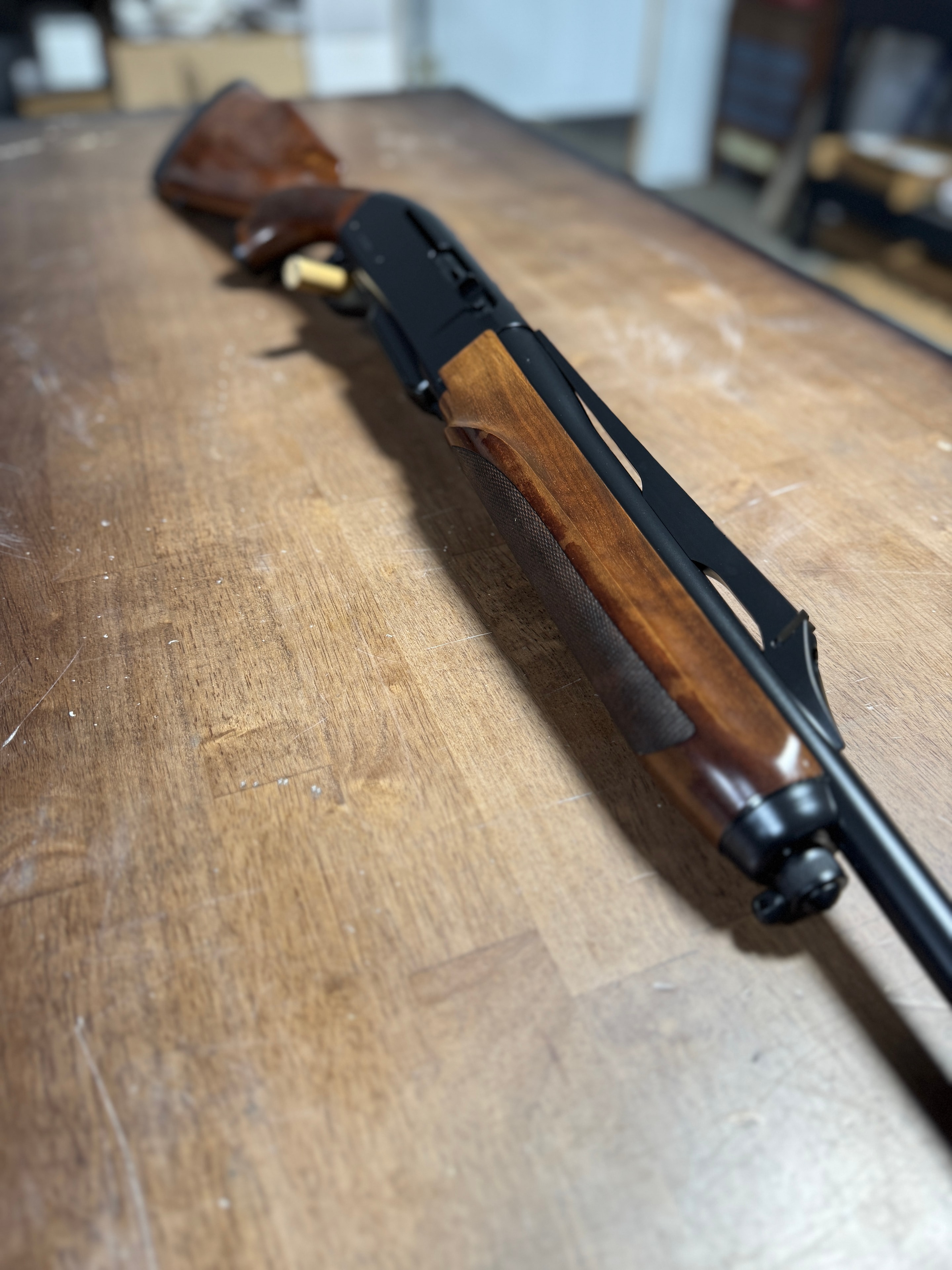 Restored Remington 870 pump-action shotgun — full profile showing reblued receiver and refinished walnut forearm and stock — by Northwoods Firearms, Crandon, WI