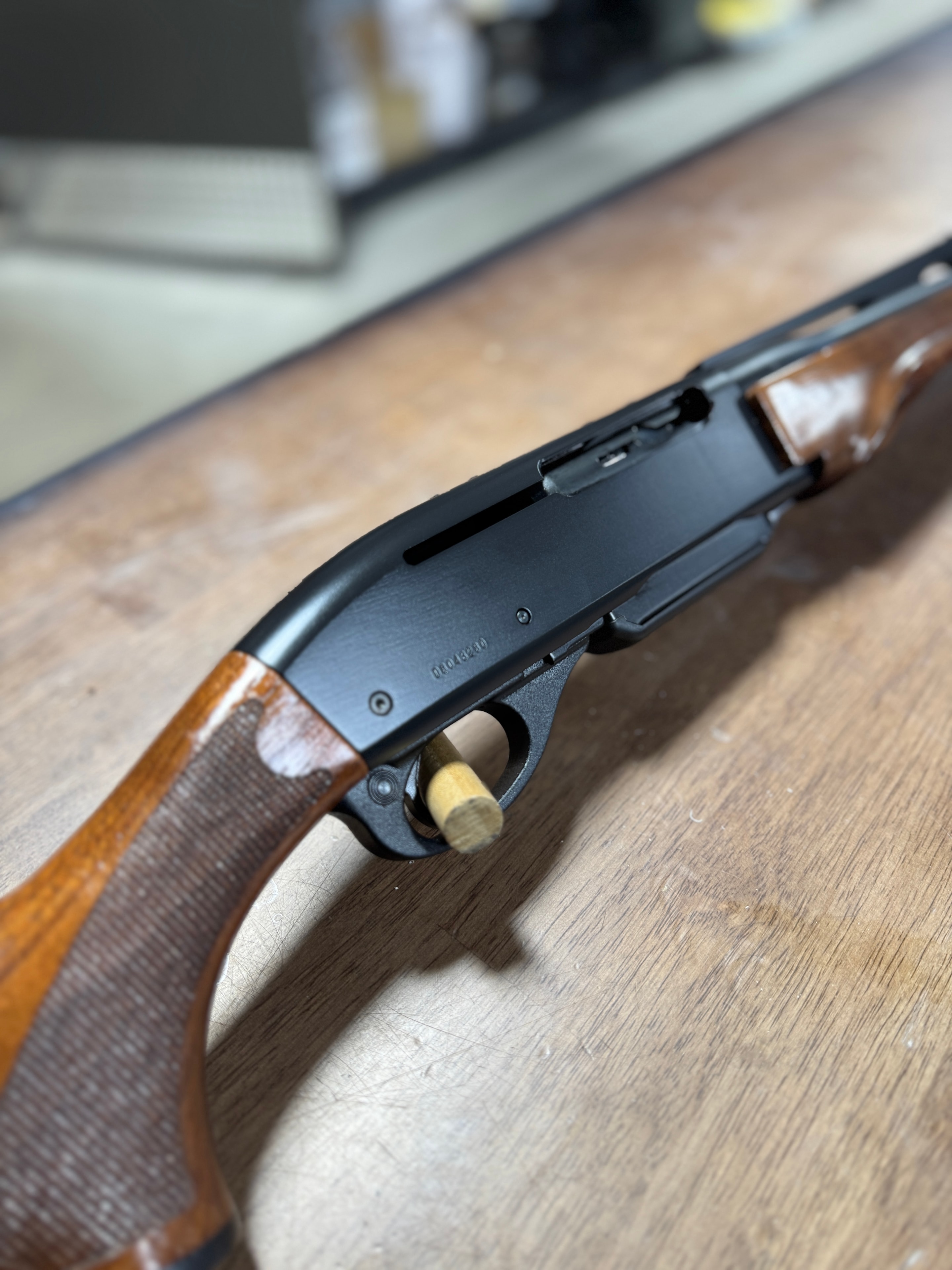 Restored Remington 870 pump-action shotgun — receiver and action detail, reblued metal and refinished walnut stock — by Northwoods Firearms, Crandon, WI