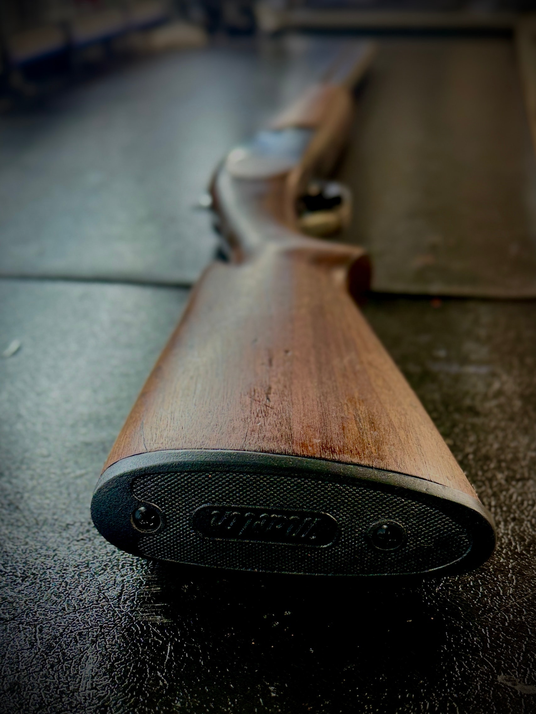 Close-up of restored rifle stock butt with Pachmayr recoil pad and refinished walnut — detail shot at Northwoods Firearms, Crandon, WI