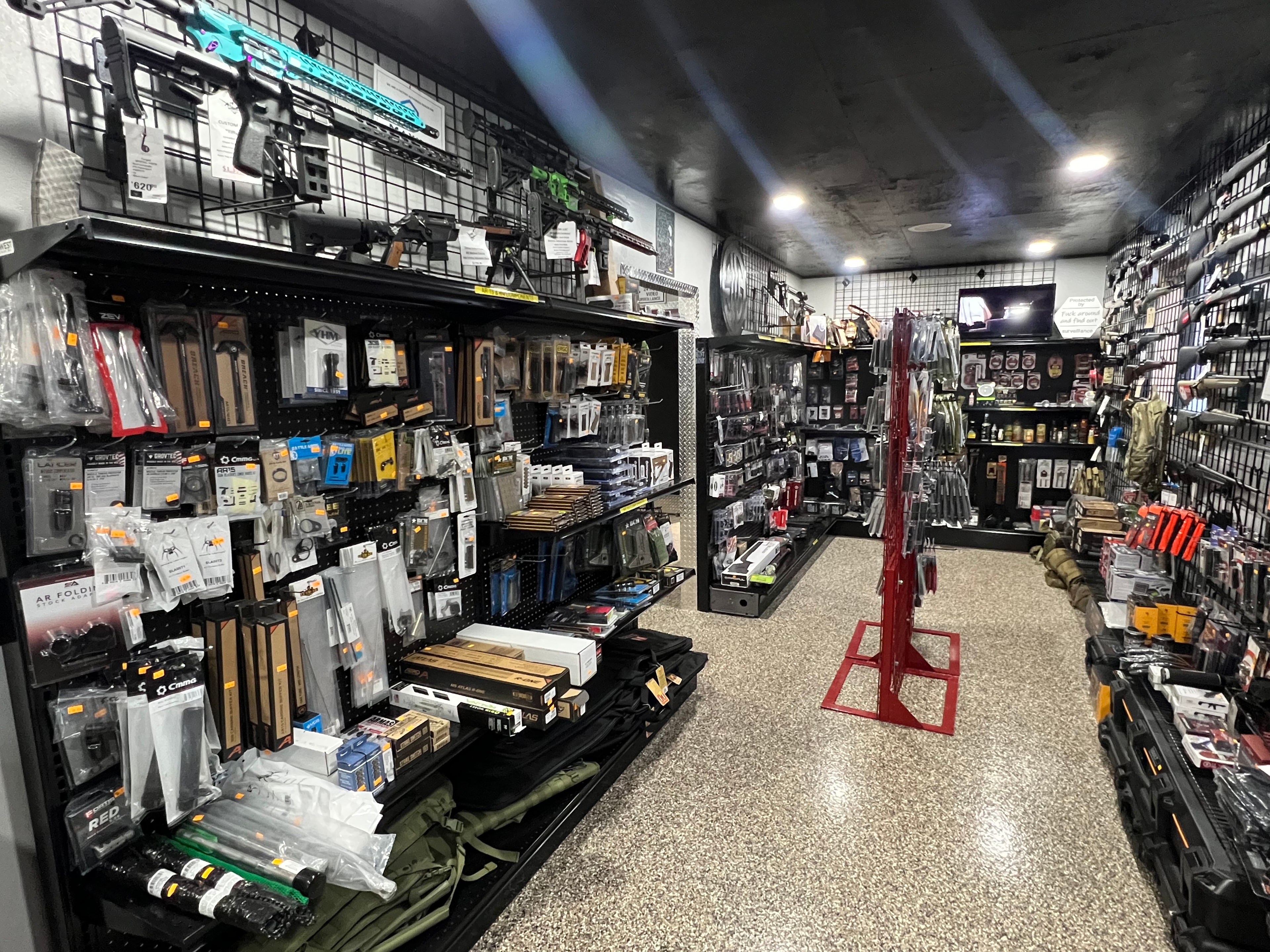 Northwoods Firearms accessories wall — AR parts, magazines, optics, and gear packed floor to ceiling