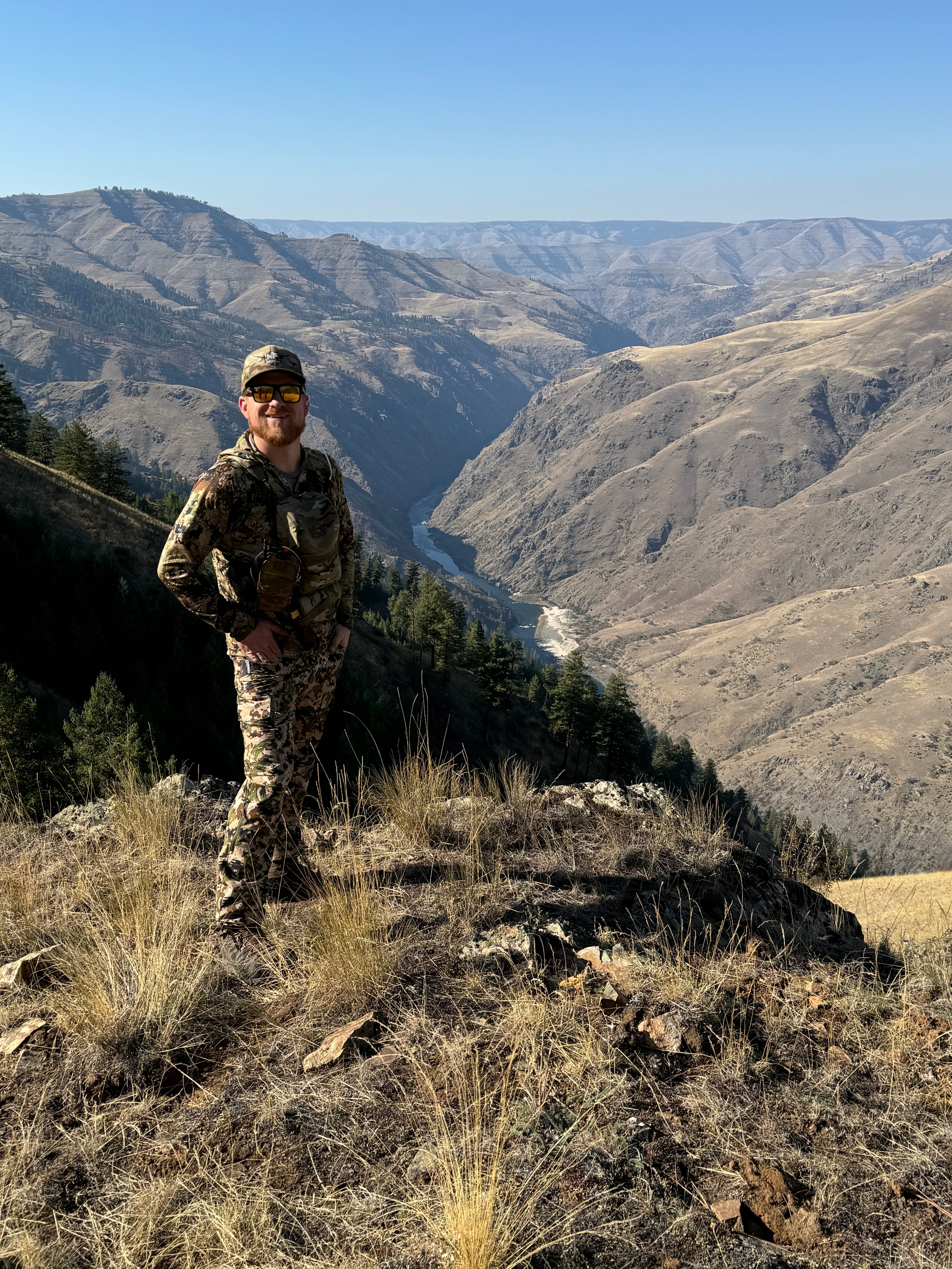 Bobby Connor in camo gear on rugged mountain canyon ridge