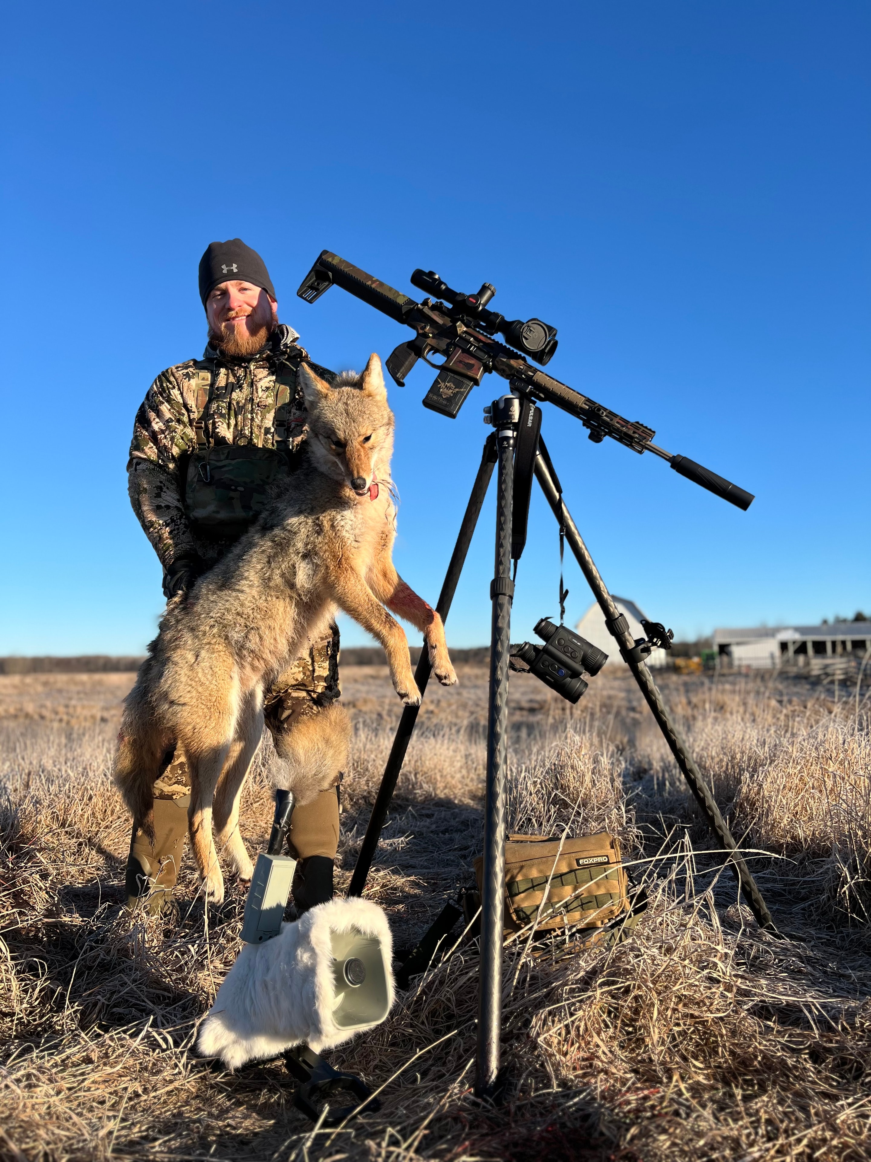 Bobby Connor with coyote harvest and custom AR setup in field