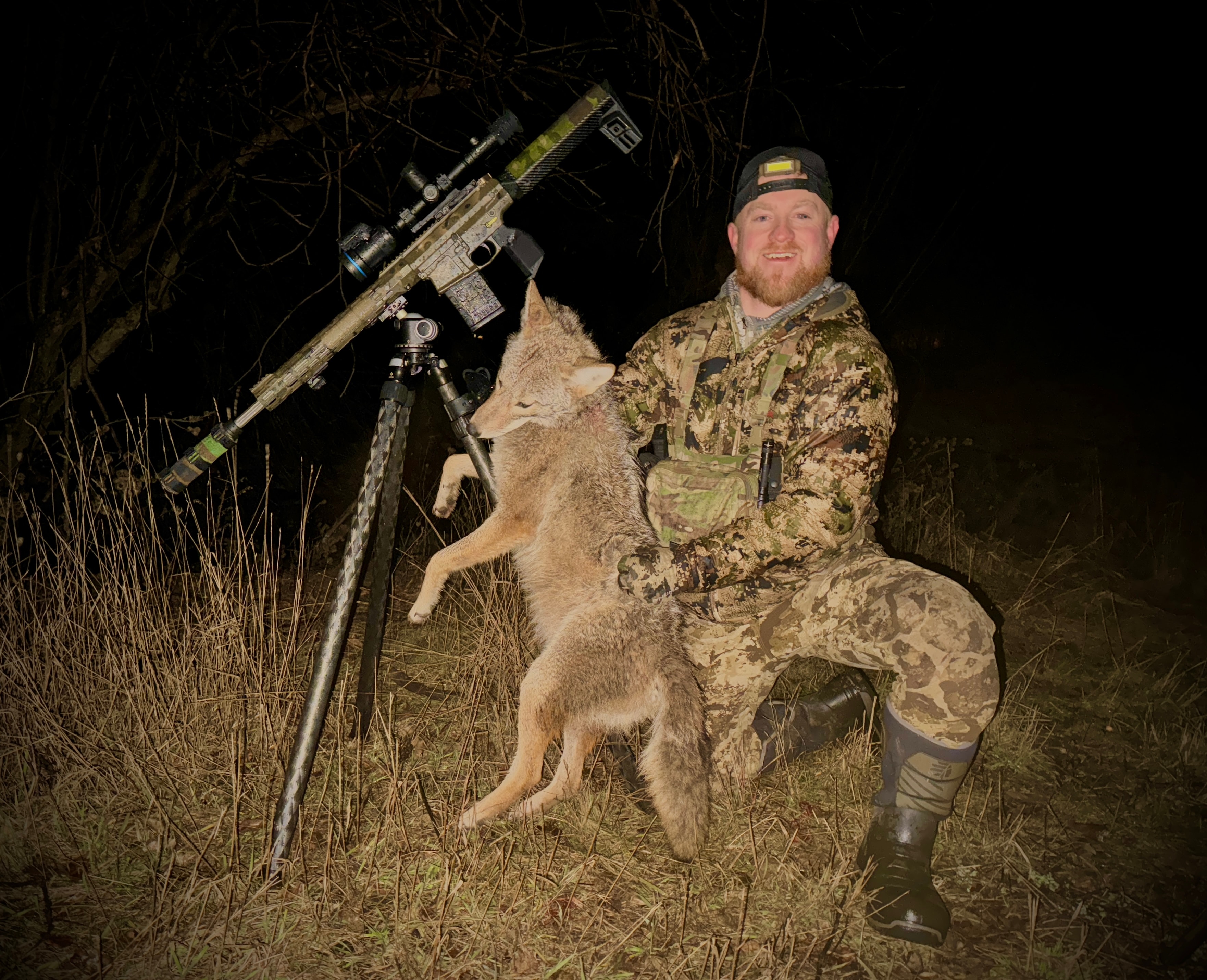 Bobby Connor with coyote and camo AR at night