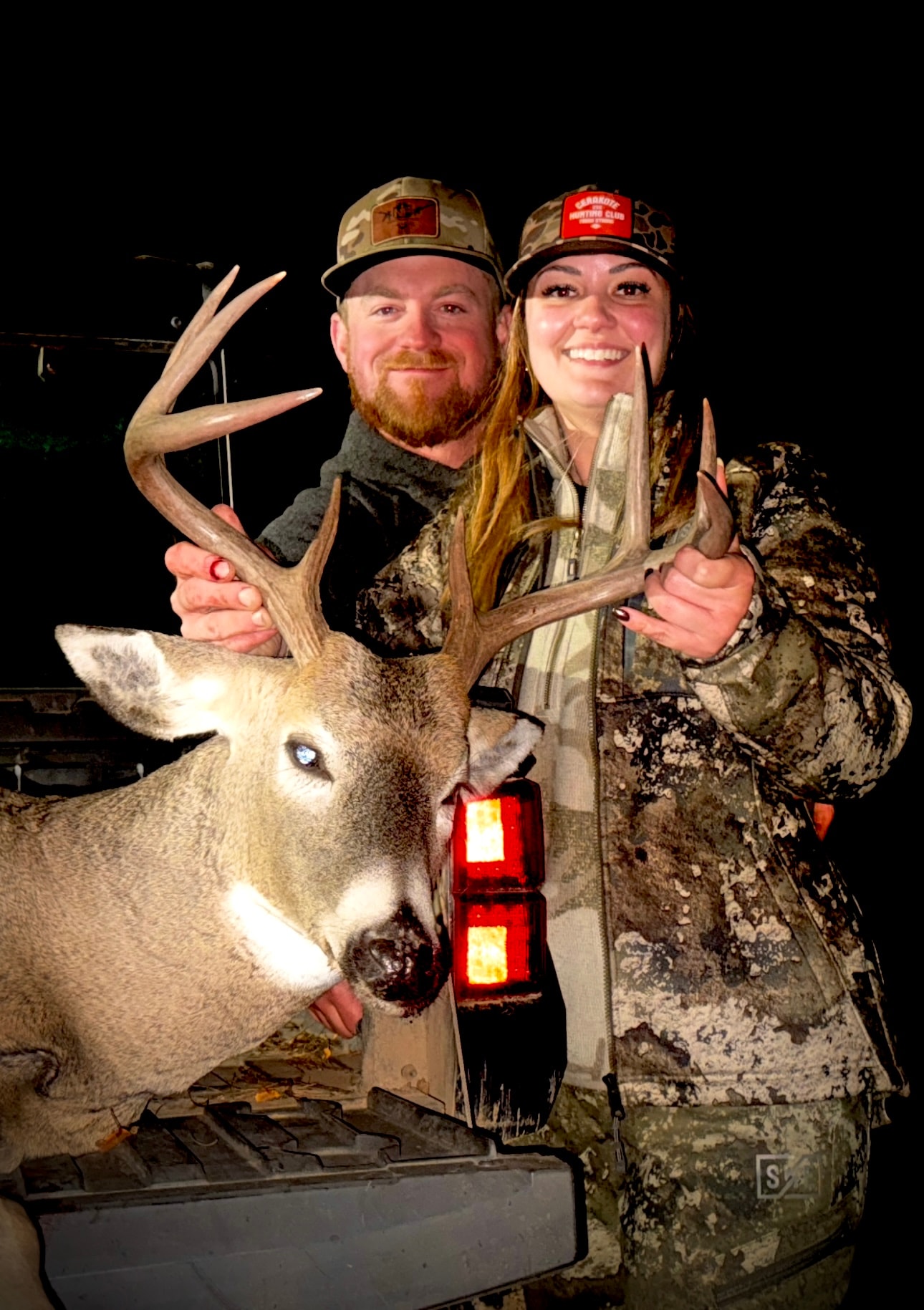Bobby and Katie Connor with whitetail buck at night